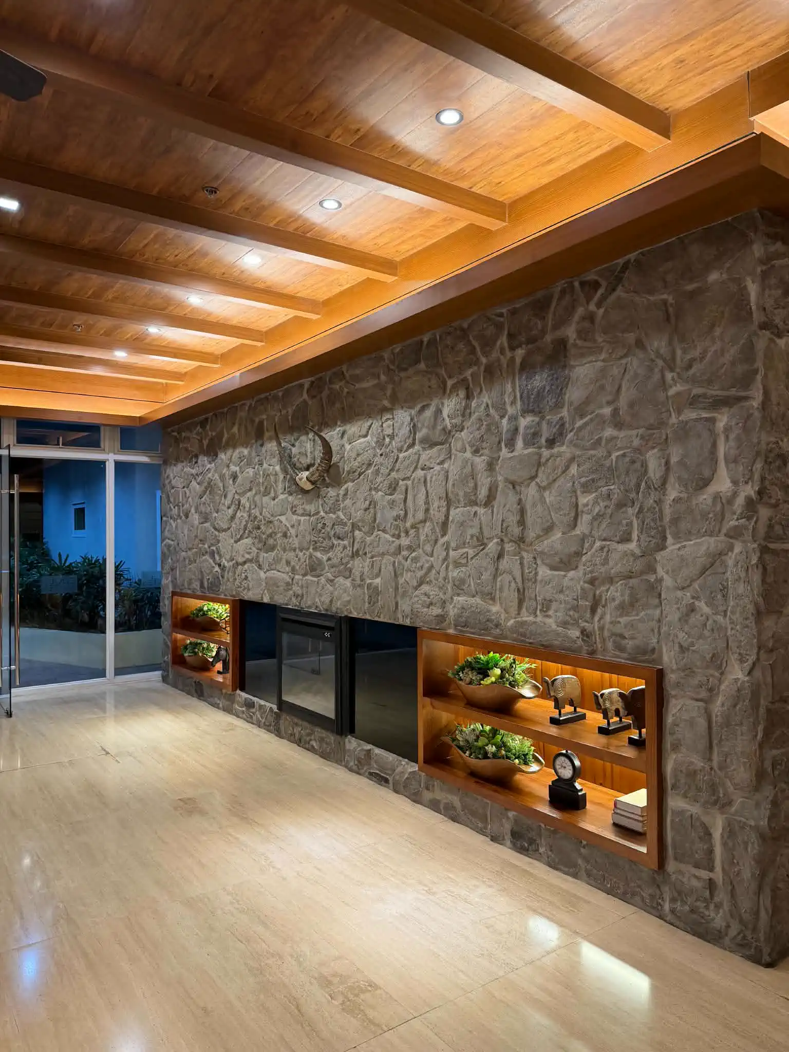 Stone fireplace and seating area at Wind Residences