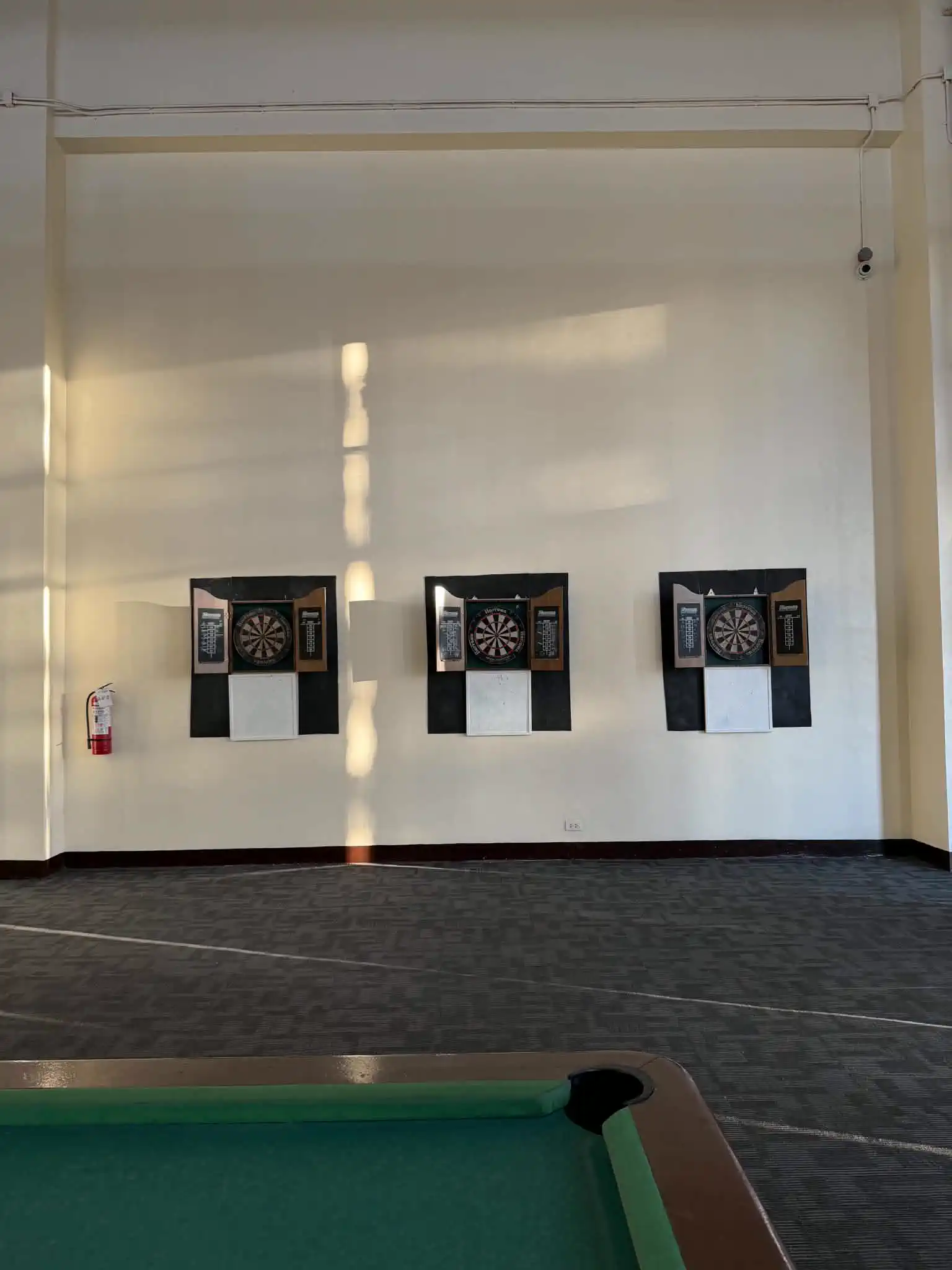 Dartboards and billiards area at Wind Residences